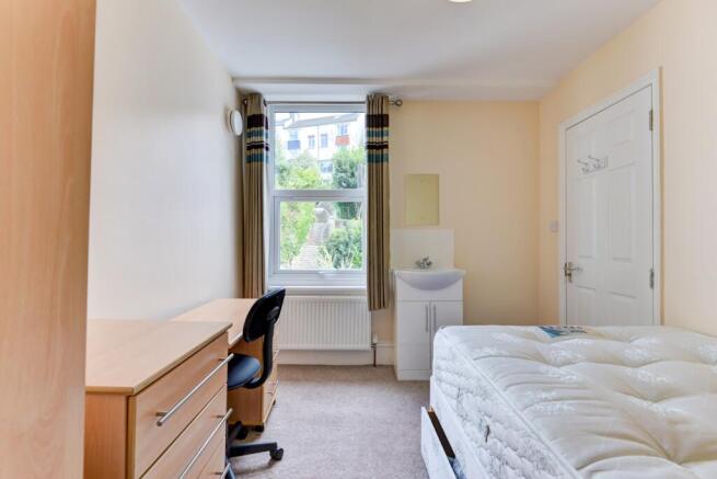 Bright, neatly presented bedroom with a large w...
