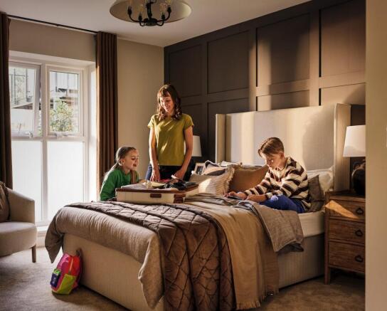 a person and a couple of kids on a bed