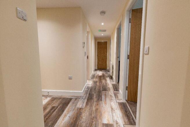 A clean and well-maintained hallway featuring m...