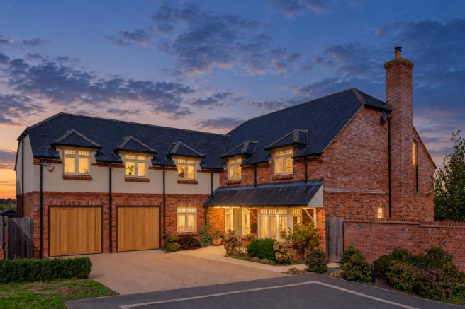 Warm-lit home at blue-hour dusk.png