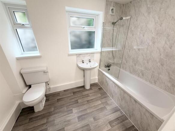 Modern bathroom with bright tiling and full bat...