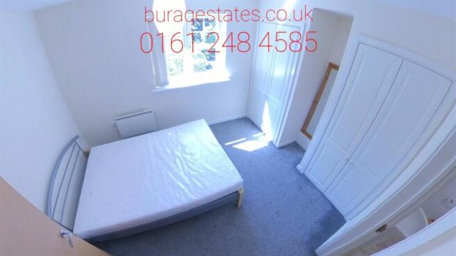 Bright, simply furnished bedroom with a double ...
