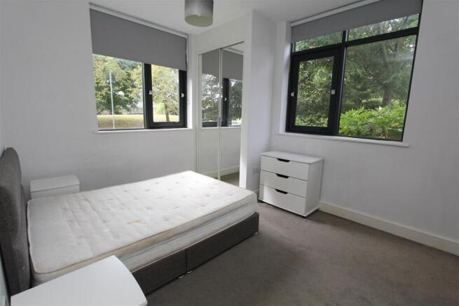 Bright modern bedroom with large windows...