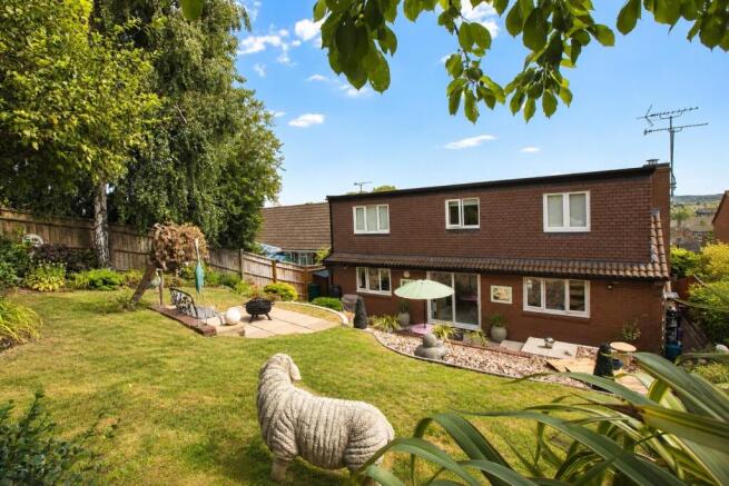 Sunny Suburban Garden with Stone Sheep Statue.jpg