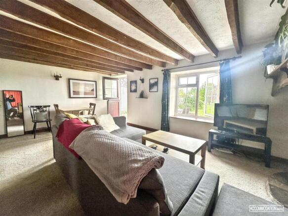 Charming lounge with exposed wooden beams...