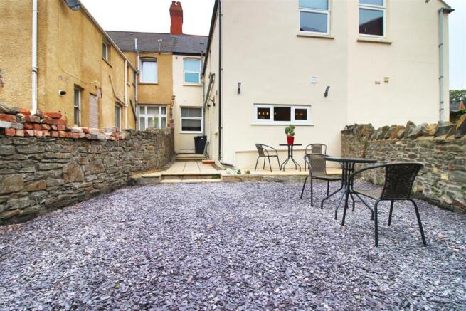 Spacious low-maintenance garden with seating ar...
