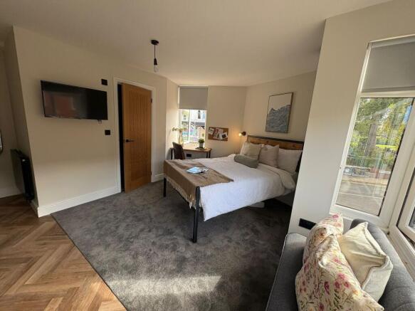 Bright, well-styled bedroom with a comfortable ...