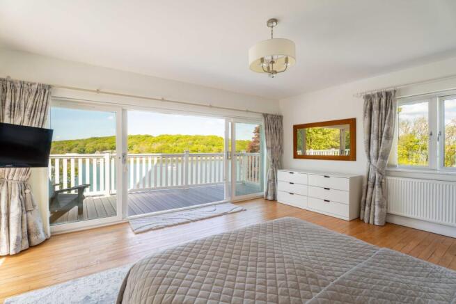Principal Bedroom with wrap around balcony and water views