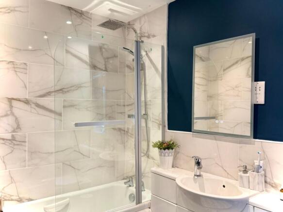 Bathroom with a shower over the bath