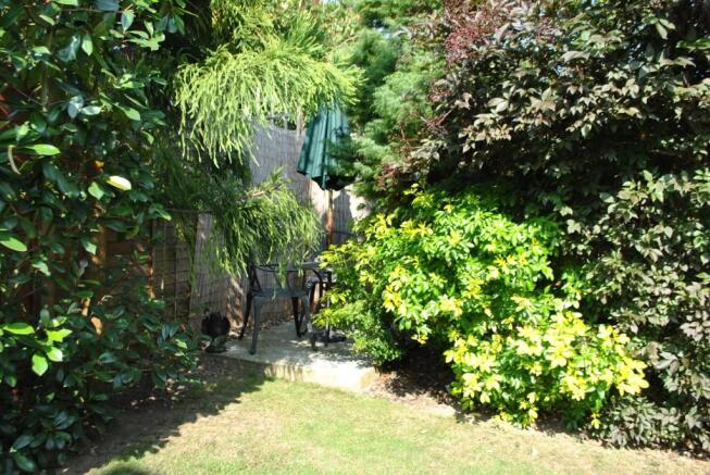 SECLUDED SEATING AREA IN GARDEN