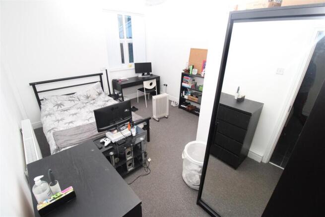 Bright bedroom with dual desks and double bed...