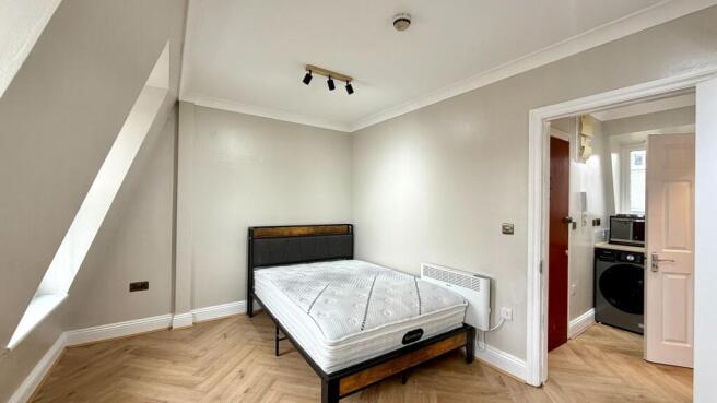 Bright, freshly painted bedroom with a modern b...