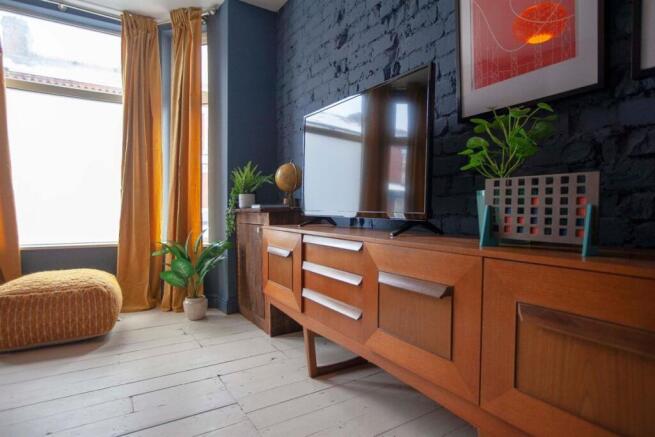 Stylish lounge with exposed brick and natural l...