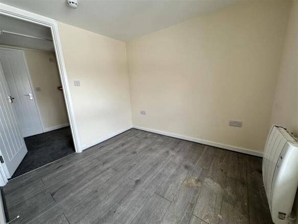 Bright bedroom with stylish wooden flooring...