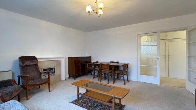 Bright, neutrally decorated living room with re...