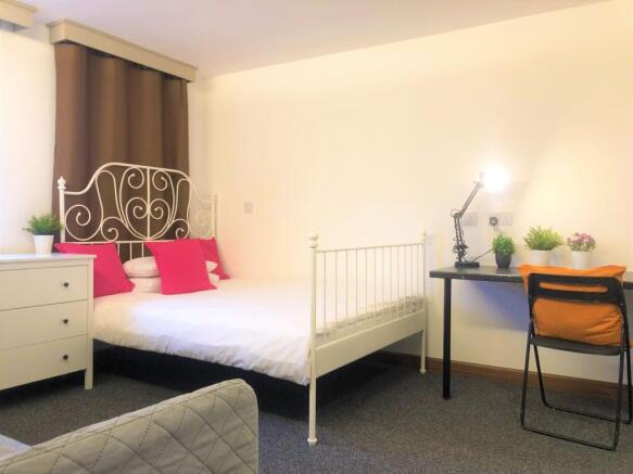 Bright and cozy double bedroom featuring an ele...