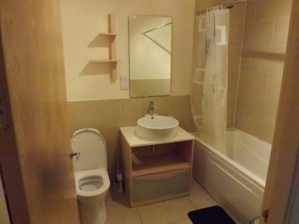 Bathroom with bath and fixed shower