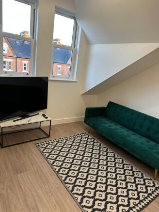 Bright, modern living room with large windows, ...