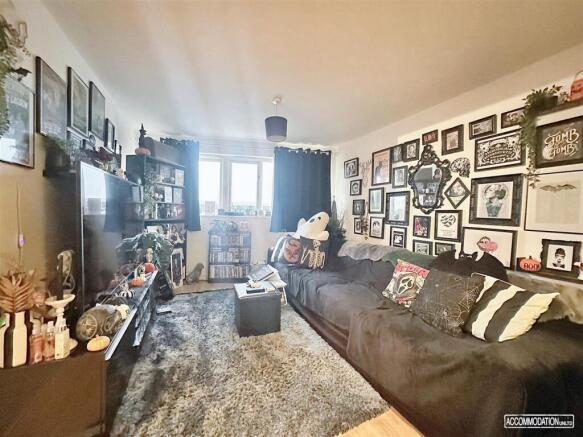 Spacious lounge with large sofa and natural lig...