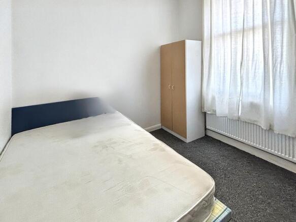 Bright and airy bedroom with large window...