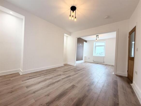 Bright, open-plan living area with wood floors...