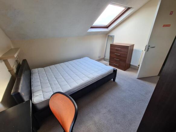 Bright and cozy double bedroom featuring a comf...