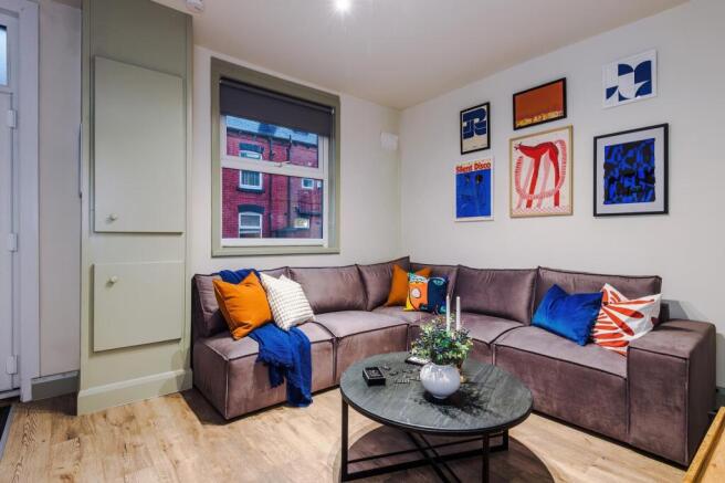 Bright, modern living room with an L-shaped sof...