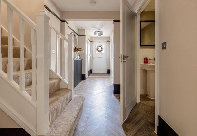 The entrance hall is welcoming with a downstairs WC