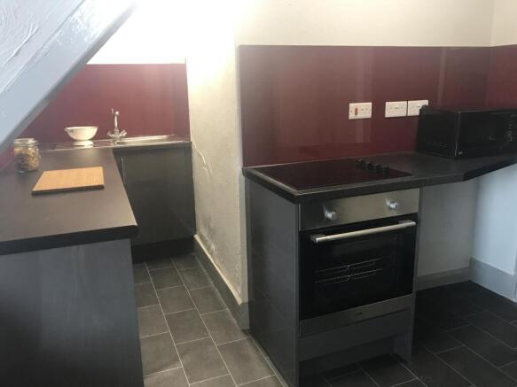 Modern kitchenette with sleek black appliances...