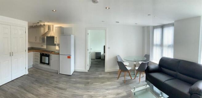 Bright open-plan living area with kitchenette...