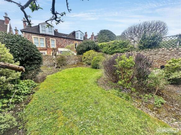 Spacious private garden with lush green lawn...
