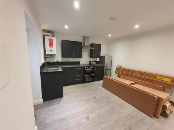 Modern kitchen with sleek dark cabinets...