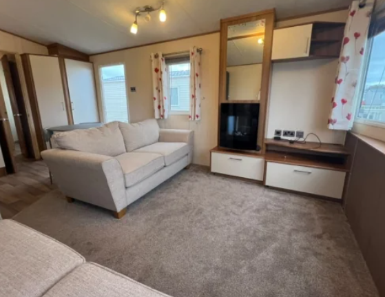Cosy Living Room With Sofas, Tv Unit And Large Win