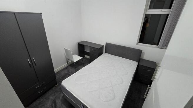 Modern double room with workspace and storage...