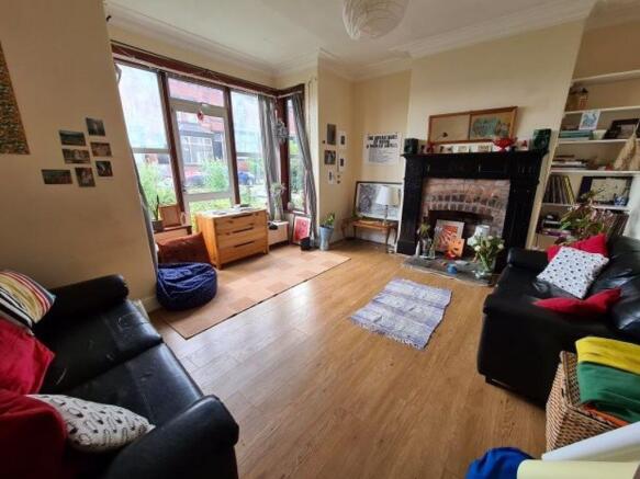 A spacious and well-lit living room featuring c...