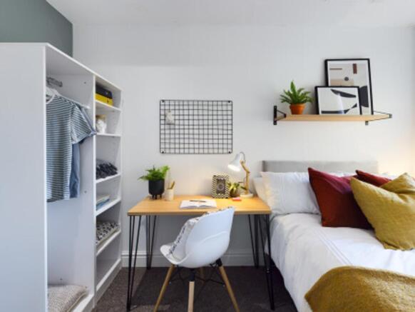 A bright and inviting double bedroom featuring ...