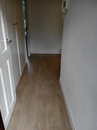 Bright hallway with stylish wood flooring...