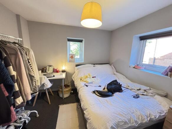 A cozy bedroom with a comfortable double bed, w...