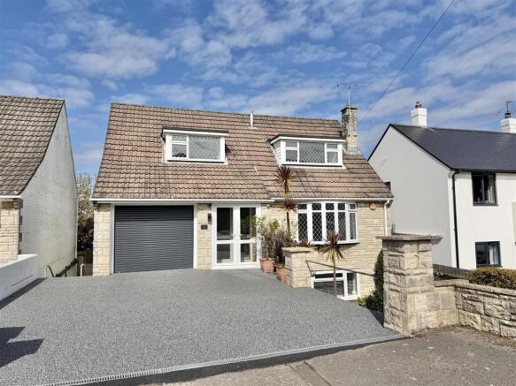 Front with drive and garage