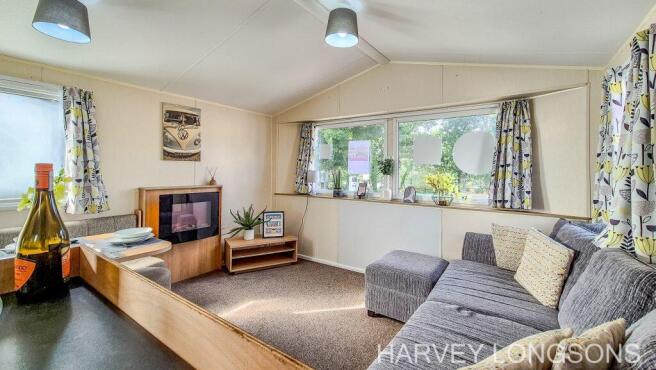 Spacious lounge with large windows and sofa