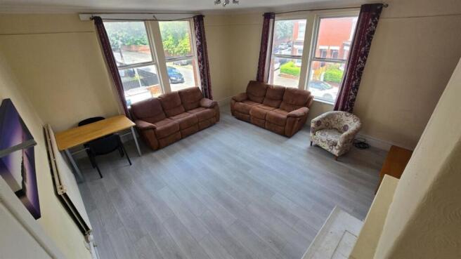 Bright, modern living room with large windows p...