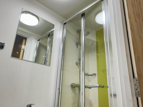 Bright modern shower with vibrant green accents...