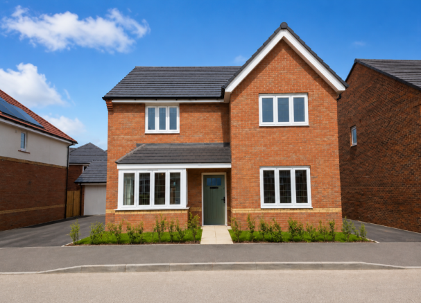 A modern brick house with white-framed windows stands on a paved driveway in the foreground