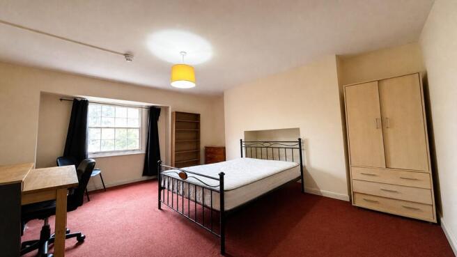 Spacious bedroom with double bed and study desk...