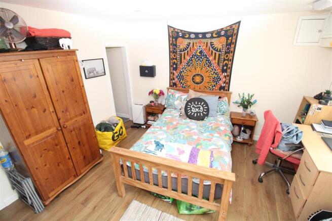 Bright master bedroom with desk and wardrobe...