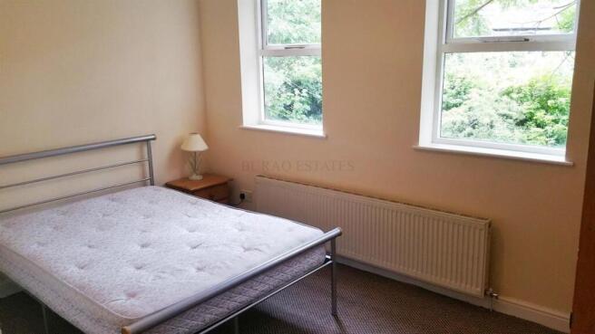 Bright bedroom with dual windows and comfy bed...