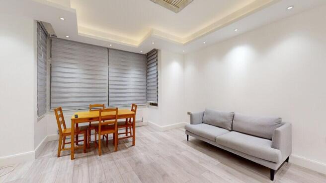 Bright modern living area with dining table...