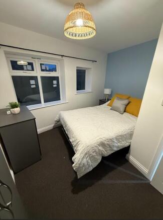 Bright, neatly presented bedroom with a comfort...