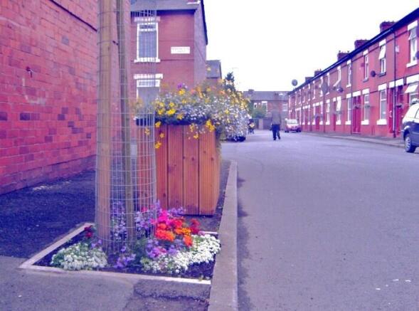 Charming street with colorful flower planters...