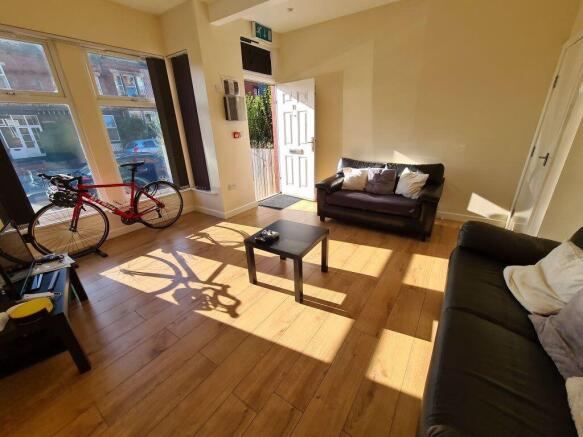 Bright and spacious living room featuring large...